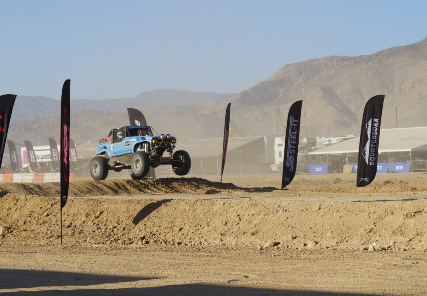 a blue color racing car jumping